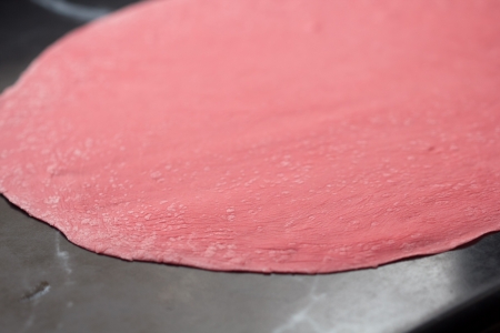 Thinly rolled pink dough for pasta with beet juiceの写真素材