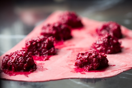 Cooking homemade pasta ravioli with beetroot stuffedの写真素材