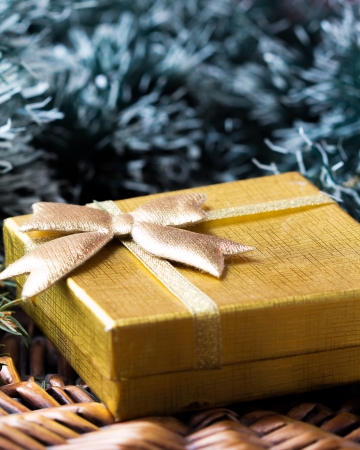 Gift in gold box under tree for Christmasの写真素材