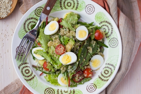 Healthy quinoa salad with tomatoes, avocados, eggs, herbs, lettuce, lemon, diet dishの写真素材