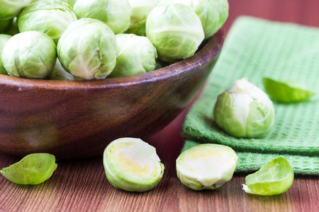 Brussels sprouts in a wooden bowl on the table, tasty, healthy vegetable bio productsの写真素材