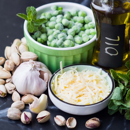 Ingredients for cooking sauce pesto with green peas, mint, cheese, oil, garlic