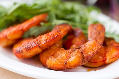 Fried spicy shrimp, prawn and salad of arugula, rukkolaの写真素材