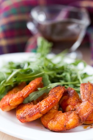 Fried spicy shrimp, prawn and salad of arugula, rukkolaの写真素材