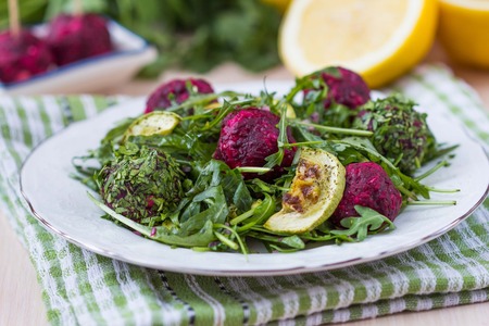 Fresh summer salad with arugula, zucchini, balls of beetの写真素材