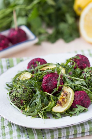 Fresh summer salad with arugula, zucchini, balls of beetの写真素材