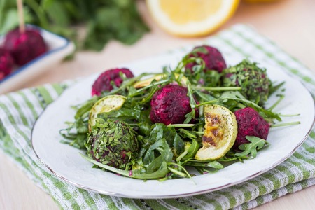 Fresh summer salad with arugula, zucchini, balls of beetの写真素材