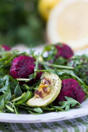 Fresh summer salad with arugula, zucchini, balls of beetの写真素材
