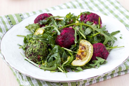 Fresh summer salad with arugula, zucchini, balls of beetの写真素材
