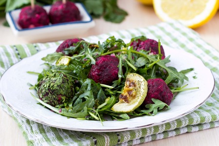 Fresh summer salad with arugula, zucchini, balls of beetの写真素材
