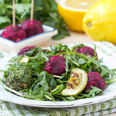 Fresh summer salad with arugula, zucchini, balls of beetの写真素材