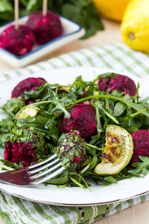 Fresh summer salad with arugula, zucchini, balls of beetの写真素材