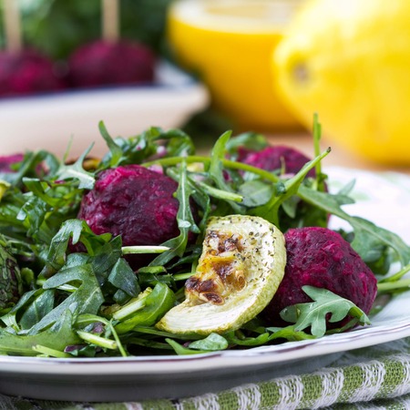 Fresh summer salad with arugula, zucchini, balls of beetの写真素材