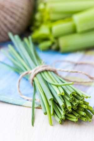 Bunch of green spring chives bow tied with ribbon, fresh vegetablesの写真素材