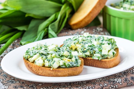 Sandwich with salad of eggs, green herb, parsley, ramson, spring onions, sauce, summer lunchの写真素材