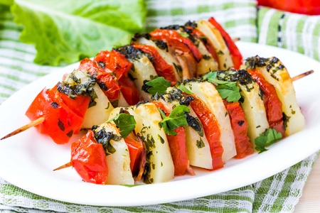 Potato vegetarian kebab, skewer with vegetables, tomato, herb on stick, tasty picnic dishの写真素材