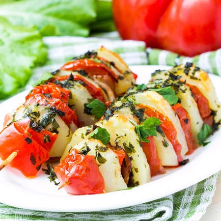 Potato vegetarian kebab, skewer with vegetables, tomato, herb on stick, tasty picnic dishの写真素材