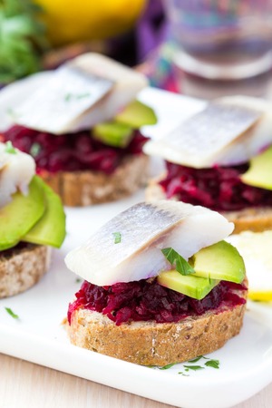 Canape herring with beets on rye toast, Russian appetizer for vodkaの写真素材