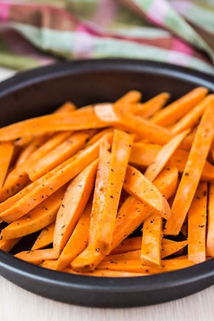 Sweet potatoes, batata, sliced, fried in pan with spices, herbの写真素材