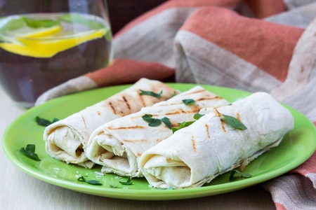 Grilled rolls of bread lavash with cheese suluguni, peppers, picnic lunch, snack, delicious dishの写真素材