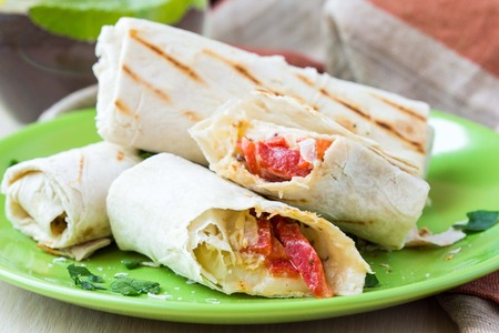 Grilled rolls of bread lavash with cheese suluguni, peppers, picnic lunch, snack, delicious dishの写真素材