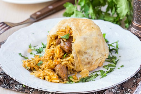 Oriental shah pilaf, pilaw, plov, rice with meat in pastry filo, delicious fragrant spicy dishの写真素材