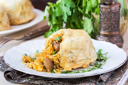 Oriental shah pilaf, pilaw, plov, rice with meat in pastry filo, delicious fragrant spicy dishの写真素材