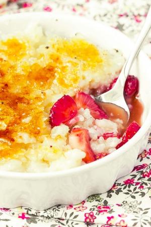 Rice dessert pudding, creme brulee with strawberriesの写真素材