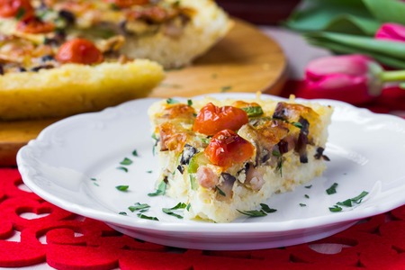 French pie quiche with tomato, ham, egg, cheese, mushrooms, tasty dishの写真素材