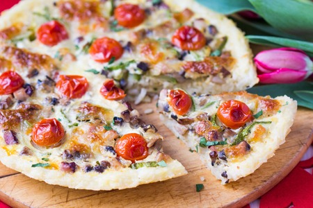 French pie quiche with tomato, ham, egg, cheese, mushrooms, tasty dishの写真素材