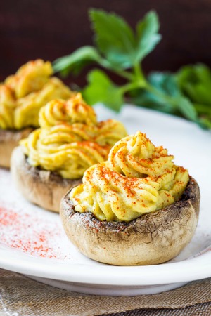 Stuffed caps  mushroom champignon yellow mousse lentils, tasty snack, appetizerの写真素材