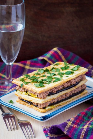 French appetizer millefeuille with eggplant, mousse, paste, cream of beans and meatの写真素材