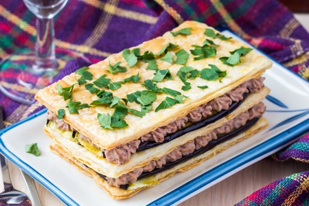 French appetizer millefeuille with eggplant, mousse, paste, cream of beans and meatの写真素材