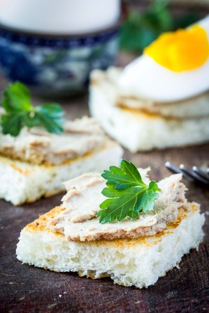 Rustic breakfast, boiled egg and toast with liver pate, tasty dishの写真素材