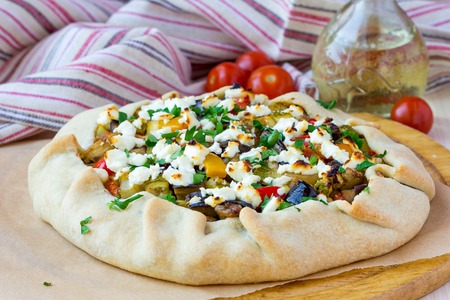 Vegetable pie with eggplant, zucchini, peppers, feta cheese, parsley, Greek dishの写真素材
