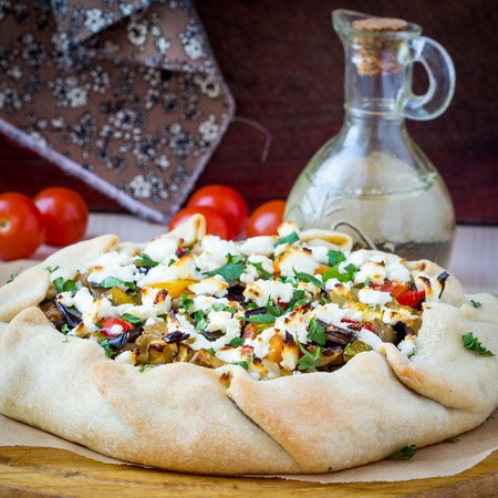 Vegetable pie with eggplant, zucchini, peppers, feta cheese, parsley, Greek dishの写真素材