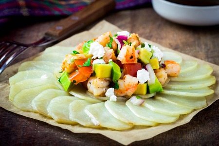 Fresh salad with shrimp, avocado, tomato on potato gratin, spring, summer, healthy dishの写真素材