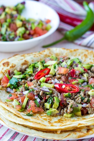 Pancakes stuffed with meat, avocado, tomatoes, onions, Mexican taste, Russian Shroveの写真素材