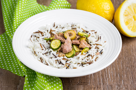 Mix of wild and white rice with canned tuna, zucchini, green olives and lemon, fresh, delicious diet dish, healthy foodの写真素材