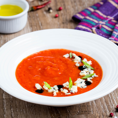 Tomato cream soup, nice presentation with blue cheese and green onions, fresh bright dish, tasty healthy foodの写真素材