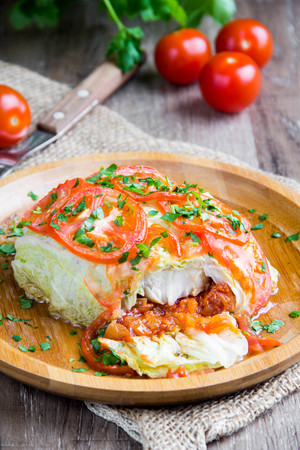Cabbage rolls, stuffed with tomatoes, fish, meat, vegetables, a delicious Russian dish, tasty healthy diet foodの写真素材