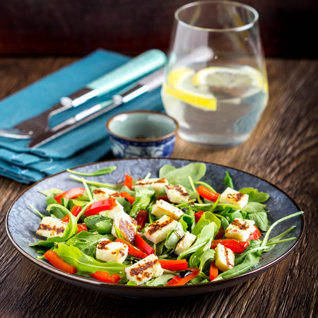 Salad with grilled cheese, spinach, tomatoes, pepper, paprika, delicious lunch diet dishの写真素材