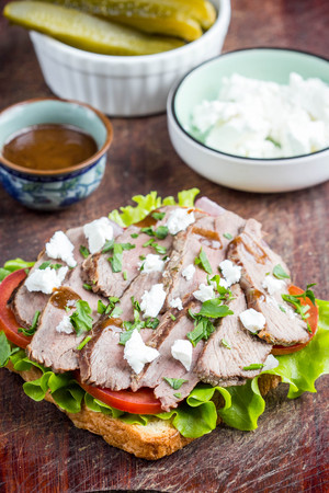 Sandwich with roast beef, tomatoes, feta cheese, fresh snacking, healthy foodの写真素材