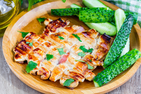 Grilled chicken fillet with bacon, golden brown, delicious dish for picnicの写真素材