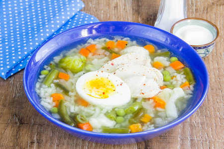 Summer vegetable soup with cabbage, beans, chicken, egg, tasty healthy dish for the diet, child's lunchの写真素材