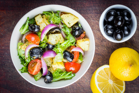 Potato salad with olives, tomatoes, lettuce, red onion, Italian dishの写真素材