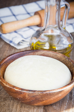 Dough in wooden bowl, yeast for pizza, pasta, cake, pieの写真素材