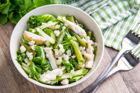 Green salad with chicken, pearl barley, fresh cucumber, french beans, wholesome hearty lunchの写真素材