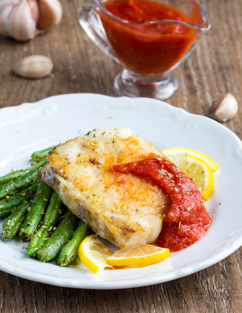 Fried white fish with green beans and tomato sauce, nice homemade meal, healthy diet tasty foodの写真素材