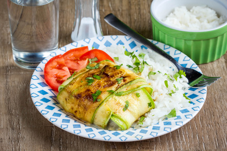 Fish grilled slices of zucchini, with tomatoes and cheese, stuffed vegetables, tasty diet food, healthy foodの写真素材